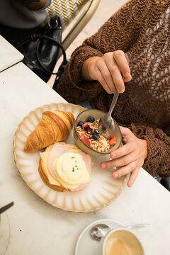 Enjoying breakfast at a cafe with croissant and yogurt