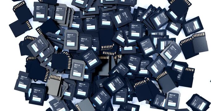 Top down view of many micro sd memory cards dropping and scattering on clean white background