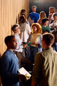 College students chat in the lecture room