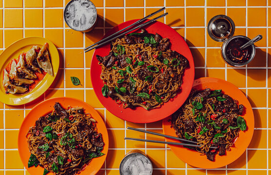Beef stir fry noodles with side of dumplings