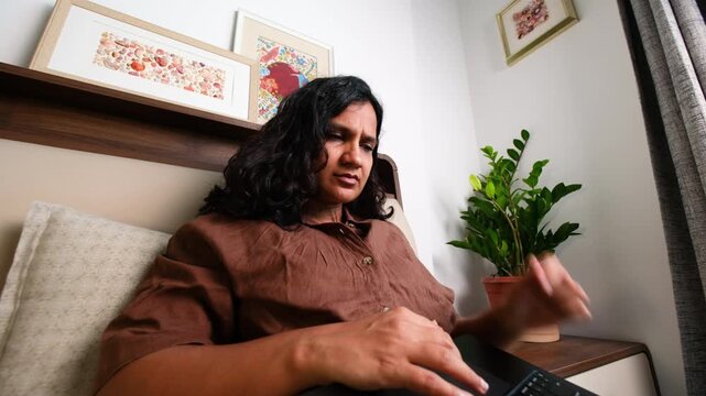 Exhausted woman struggling to work on laptop at home, remote job fatigue, stress, low energy, mental health, overwork and burnout concept
