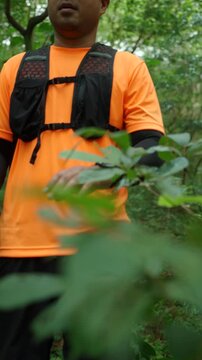 Man trail running through a forest during an outdoor workout. He challenges himself to improve fitness and endurance while pursuing personal goals and a healthy active lifestyle.
