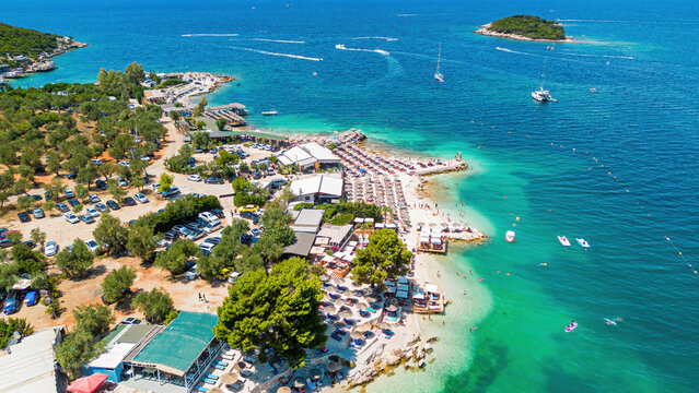 Aerial drone view of Ksamil beach with turquoise water along the coast of the Ionian Sea in southern Albania