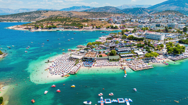 Aerial drone view of Ksamil beach with turquoise water along the coast of the Ionian Sea in southern Albania