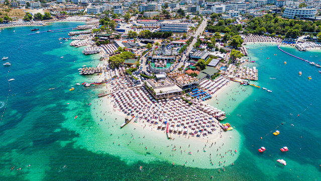 Aerial drone view of Ksamil beach with turquoise water along the coast of the Ionian Sea in southern Albania