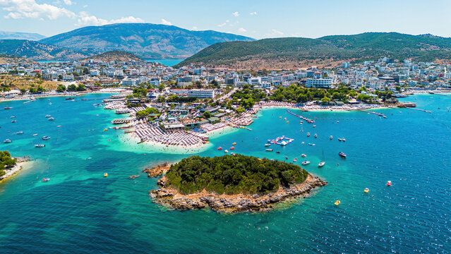 Aerial drone view of Ksamil beach with turquoise water along the coast of the Ionian Sea in southern Albania