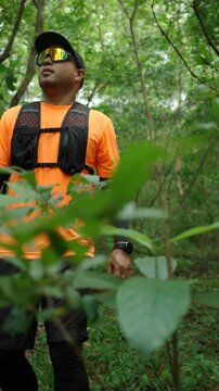 Man trail running through a forest during an outdoor workout. He challenges himself to improve fitness and endurance while pursuing personal goals and a healthy active lifestyle.
