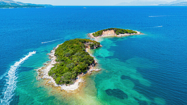 Aerial drone view of the twin Ksamil islands (Ishujt Binjak&euml;), turquoise waters, and scenic coastline in southern Albania