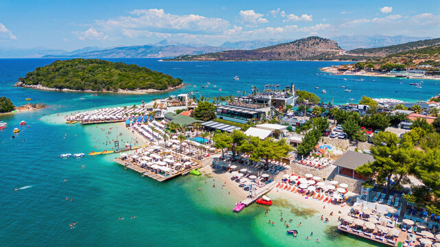 Aerial drone view of Ksamil beach, turquoise water, and islands in southern Albania