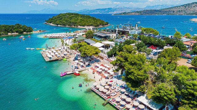 Aerial drone view of Ksamil beach, turquoise water, and islands in southern Albania