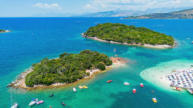 Aerial drone view of the lush green Ksamil islands surounded by turquoise waters in southern Albania