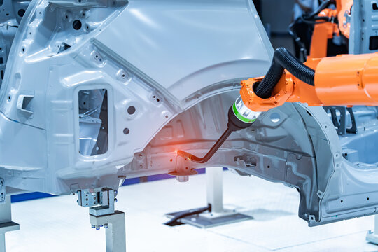Industrial robotic welders weld the car body on factory. Machine robot arm. Smart industry. Automobile production