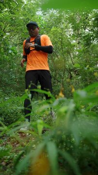Man trail running through a forest during an outdoor workout. He challenges himself to improve fitness and endurance while pursuing personal goals and a healthy active lifestyle.
