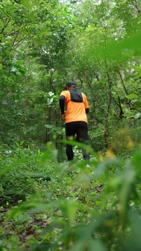 Man trail running through a forest during an outdoor workout. He challenges himself to improve fitness and endurance while pursuing personal goals and a healthy active lifestyle.
