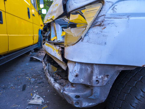 Damaged Front End of Silver Vehicle After Collision