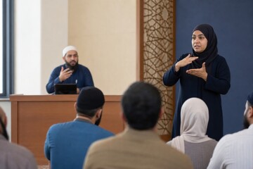 Fototapeta premium Muslim woman presenting sign language to a seated audience in a mosque classroom. Inclusive religious education, community communication, accessibility and cultural understanding concept.