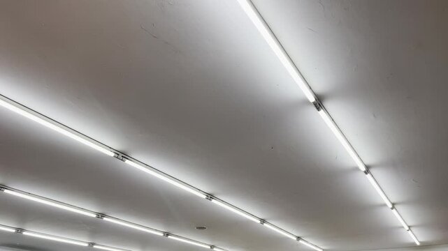 Minimalist commercial building indoor illumination design with linear light bars