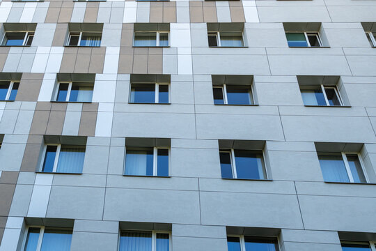 Repeating rows of windows and geometric facade panels on a modern contemporary building