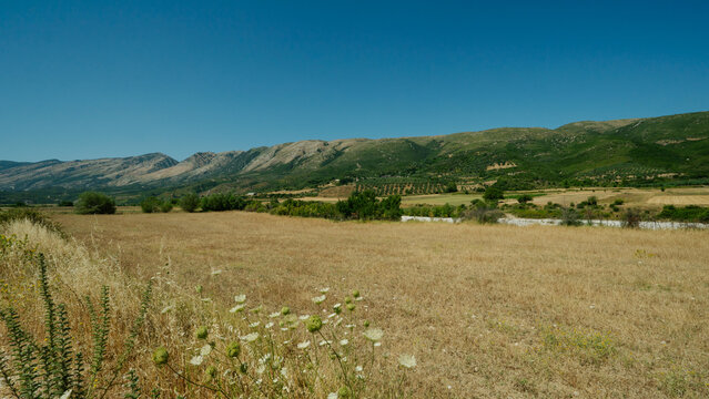 Dry Fields and Mountain Foothills in the Vlora Countryside