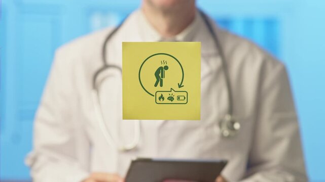 Professional medical doctor holding a tablet and showing a sticker with an icon representing fatigue, exhaustion, burnout, low energy, and related symptoms in a modern hospital setting