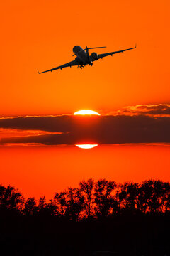 Business jet take off against the backdrop of crimson sunset