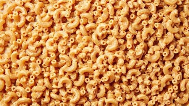 Raw dry macaroni pasta background texture, uncooked elbow noodles food pattern