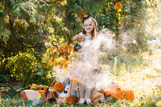 Girl Enjoys Halloween in Autumn With Pumpkins and Spiderwebs in a Sunny October Setting