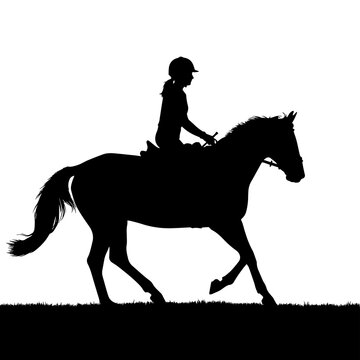 Black silhouette of a young equestrian rider on a horse trotting on grass