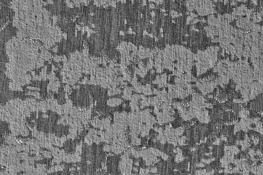 Close up grey textured fabric featuring floral jacquard weave and metallic sheen details.