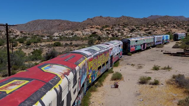 Aerial Abandoned Caltrain Passenger Cars California Desert Graffiti Fly Through