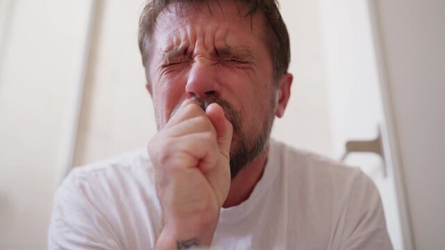 Close-up of man straining during difficult bowel movement on toilet before relaxing with relief, illustrating constipation, digestive discomfort, bowel problems and relief after using restroom.