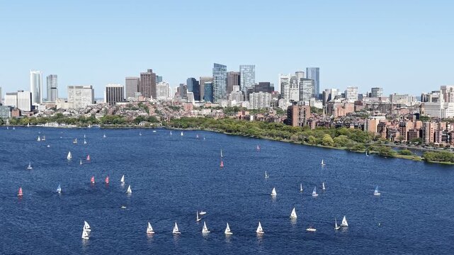 Aerial view of Boston skyline and sailboats competition on the Charles River in Massachusetts, USA on a clear summer day. g.