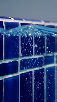 Water Splashing Against Blue Tiled Pool Edge, Creating a Dynamic Ripple Effect and Splashing Droplets. with Pool Tiles
