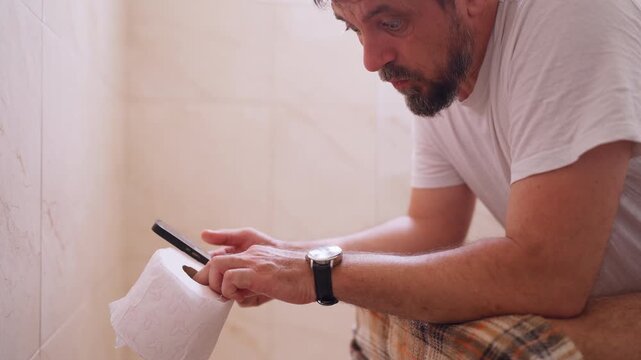 Busy professional checking his wristwatch in disbelief after spending too long in the bathroom, highlighting work pressure, lost productivity, time management and demanding daily schedules.