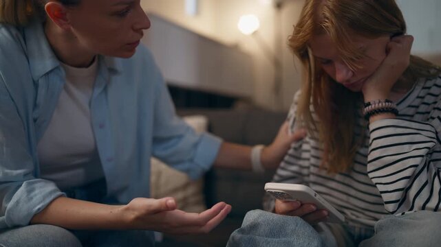 Mother trying to communicate with teenage daughter who remains focused on smartphone. Concept modern parenting challenges, family boundaries, adolescent behavior and parental guidance.