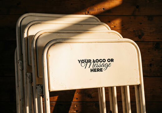 Stacked Metal Chairs Against Wooden Wall Logo Design Mockup