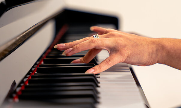 Woman playing piano keys creating music