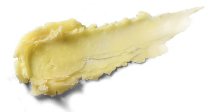 Thick smear of pale yellow cocoa butter on white background with textured brush strokes and soft shadow, with cream, balm, skincare, texture detail