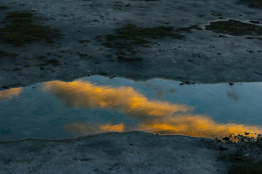 Reflection of Golden Clouds and Blue Sky in Water at Hunder Sand Dunes, Nubra Valley, Ladakh, India
