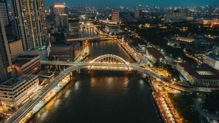 Obraz premium Aerial view of Binondo-Intramuros Bridge and Manila cityscape over Pasig River at night in the Philippines