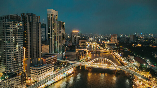 Binondo Intramuros Bridge, Manila skyline, and Pasig River at night with illuminated city lights in the Philippines