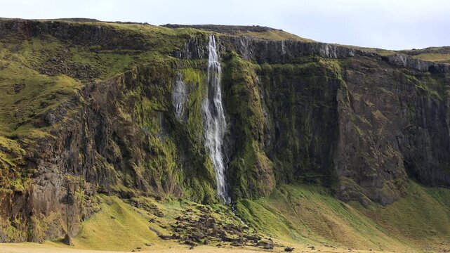 Waterfall dropping down the cliffs along the Ring Road in southern Iceland