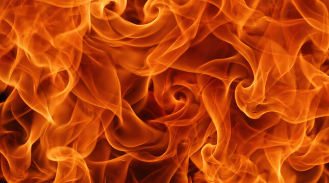 Intense orange fire flames abstract texture background with swirling heat patterns