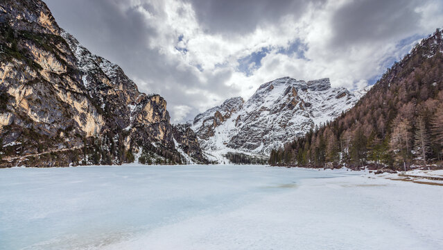 Lake Braies (Pragser See) in South Tyrol in winter, view of snowy mountain and Lake, Snow-covered Pragser Wildsee surrounded by steep, rocky mountains. 