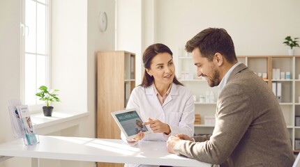 Fototapeta premium Pharmacist explaining wellness information to patient using digital tablet