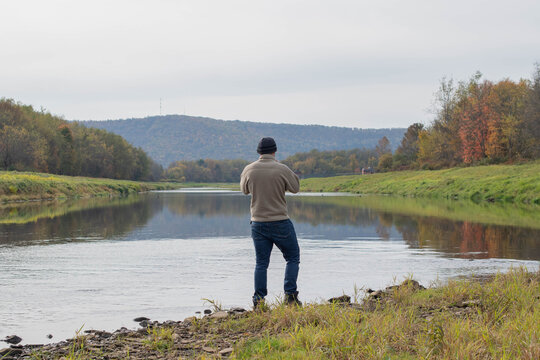 Fall autumn hiker enjoying river view, autumn activities copy space authentic backgrounds, people outdoors