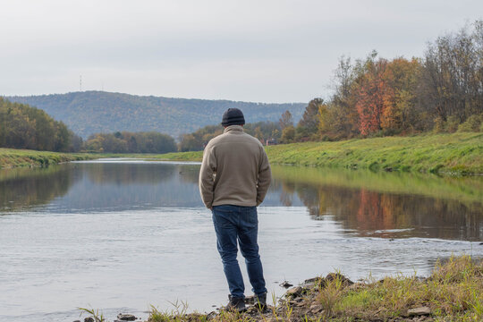 Fall autumn hiker enjoying river view, autumn activities copy space authentic backgrounds, people outdoors