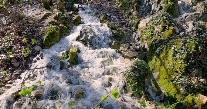 Cascade waterfall on mountain river with refreshing water