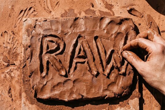 Handcrafted clay art with raw lettering and textured artisan surface