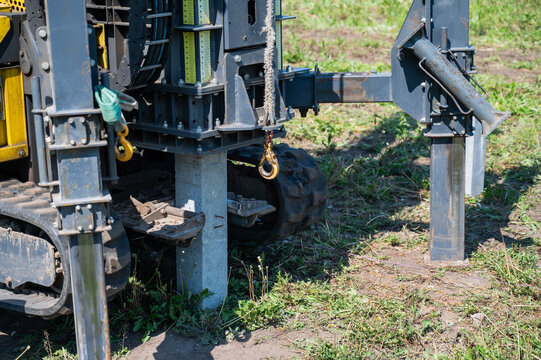 Diesel hammer drives concrete piles for a country house.